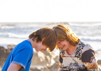 mother and son enjoy the afternoon sun at the beach