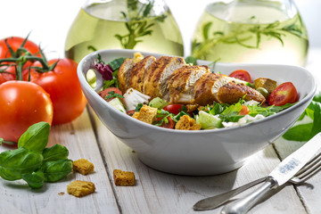 Closeup of healthy salad with chicken, tomato and olive
