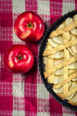 Apple pie on the table with tea towels