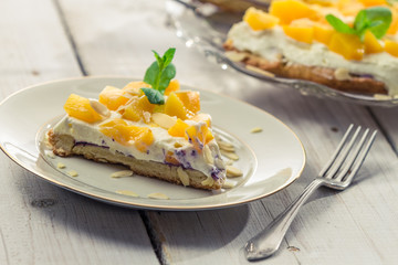 Closeup of cake with cream and peaches