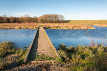 Wooden gangway over  blue rippling water