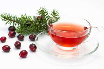 Cup of tea with fresh red cranberries