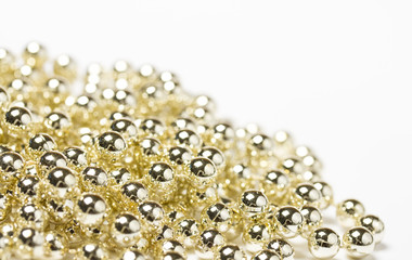 Close up image of gold christmas shiny bead decorations