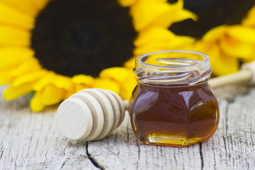honey and sunflower on old wooden background