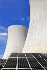 Solar energy panels before a nuclear power plant