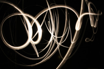 Abstract glowing neon light curves in gold