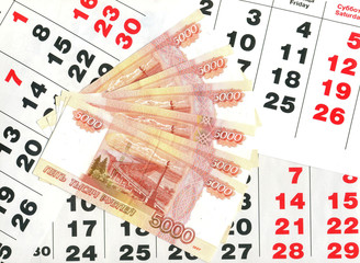 Деньги на листах календаря - obrazy, fototapety, plakaty