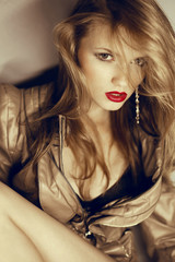 Portrait of a beautiful blonde girl with sexy red lips. Studio s