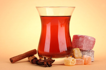 glass of Turkish tea and rahat Delight, on beige background