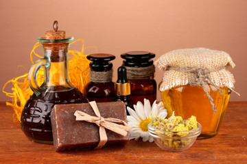 ingredients for soap making on brown background