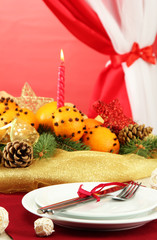 beautiful christmas table setting with tangerines and fir tree,