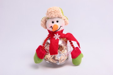 Cheerful snowman with candy.