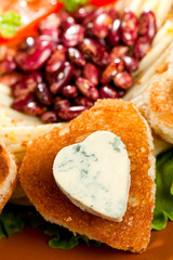 decorated fried bread and blue cheese in the shape of a heart.