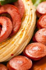 Grilled sausage with pasta, vegetables and spices