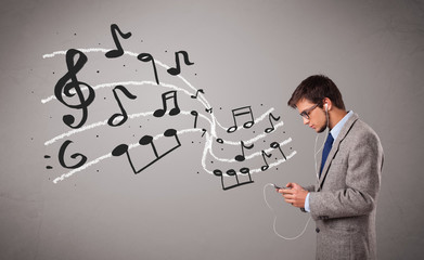 handsome boy singing and listening to music with musical notes