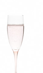 Glass of pale pink champagne on white background
