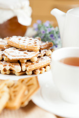 morning tea with a golden waffles with powdered sugar