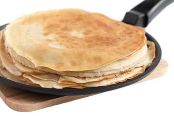 thin dairy pancakes in a frying pan