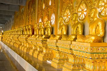 row of golden monk buddhist statues in thai temple, Chaimongkhol