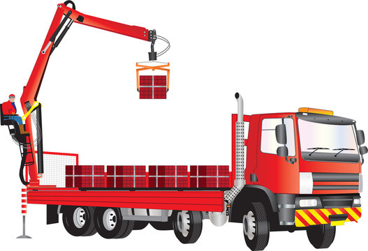 A Red Truck with operator on crane unloading bricks