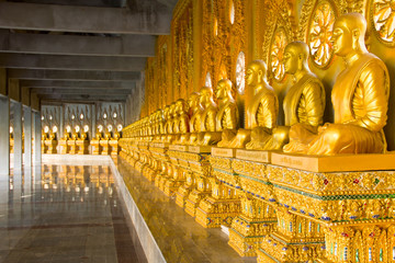 row of golden monk buddhist statues in thai temple, Chaimongkhol