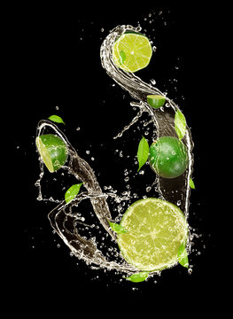Limes in water splash, isolated on black background