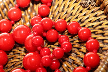 Red Necklace over brown basket background