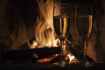 glasses of champagne in front of fireplace