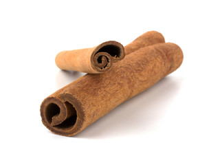 Two cinnamon sticks stacked on white background