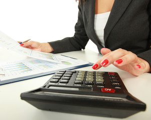 Young woman using a calculator