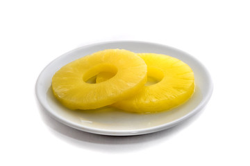 Pineapple rings on white dish isolated