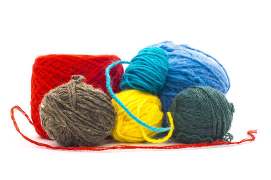 Assortment of knitting yarns on white background