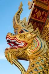 Fototapeta na wymiar golden serpent statue head in buddhist thai temple in thailand