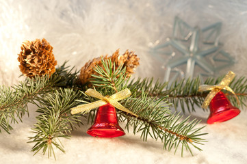 Fototapeta na wymiar Christmas background with a branch of blue spruce and bells