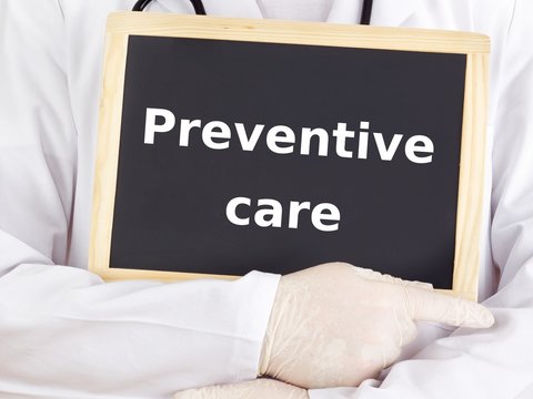 Doctor shows information on blackboard: preventive care