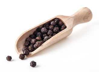 Black pepper in a wooden spoon isolated on the white background