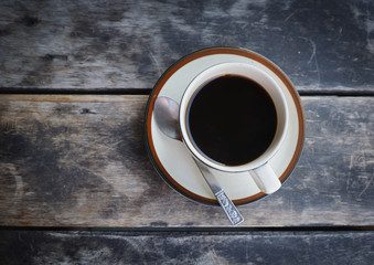 Coffee cup on old wooden table.