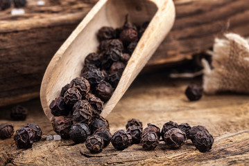 Black pepper on the rustic old wooden table