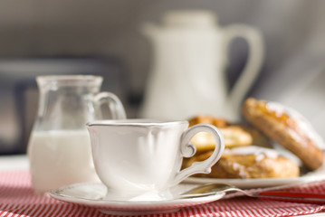 Cup of coffee with a brioche