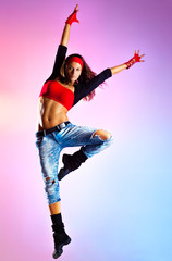 Young woman dancer jumping