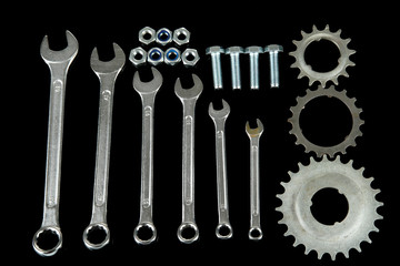 Machine gear, metal cogwheels, nuts and bolts isolated on black