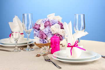 Fototapeta na wymiar Table setting in purple tones on color background
