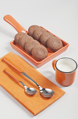 Brown biscuits and cup of milk