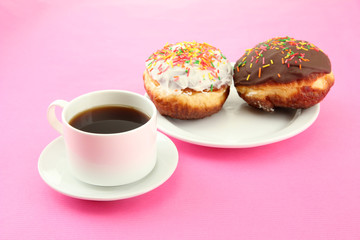 Tasty donuts on color plate on color background
