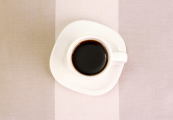 Cup of coffee on brown background