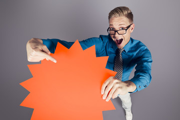 Enthusiastic salesman pointing at empty sign with space for text