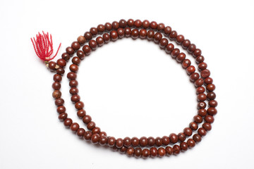Prayer beads made from sandalwood in a white background
