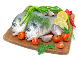 Dorado fish and vegetables on white background