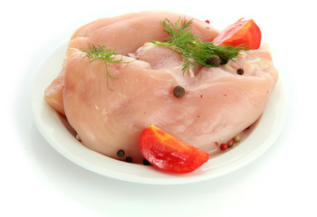 raw chicken meat with spices on plate, isolated on white