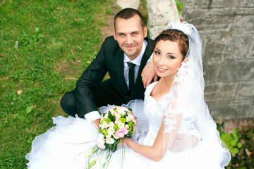 Bride and groom posing in park